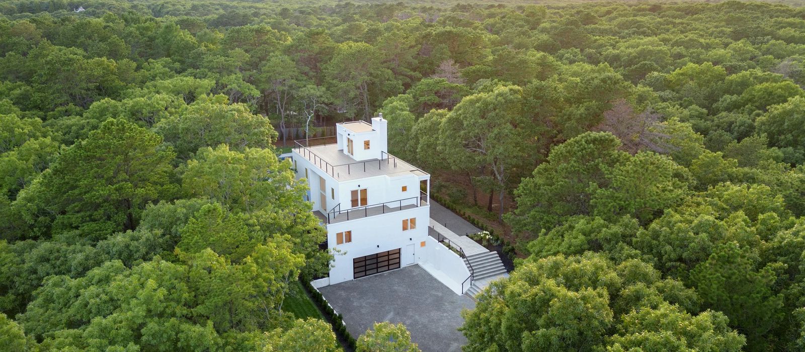 Aerial view of the residence set within the Wainscott woodland