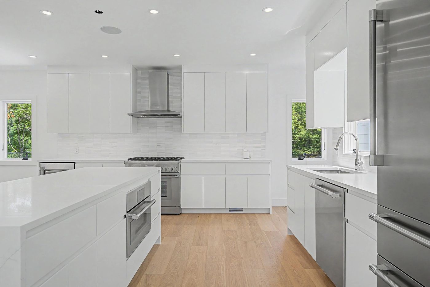 Kitchen with Thermador range, quartz island and wine refrigerator